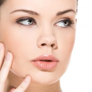 model with clear skin looking off frame